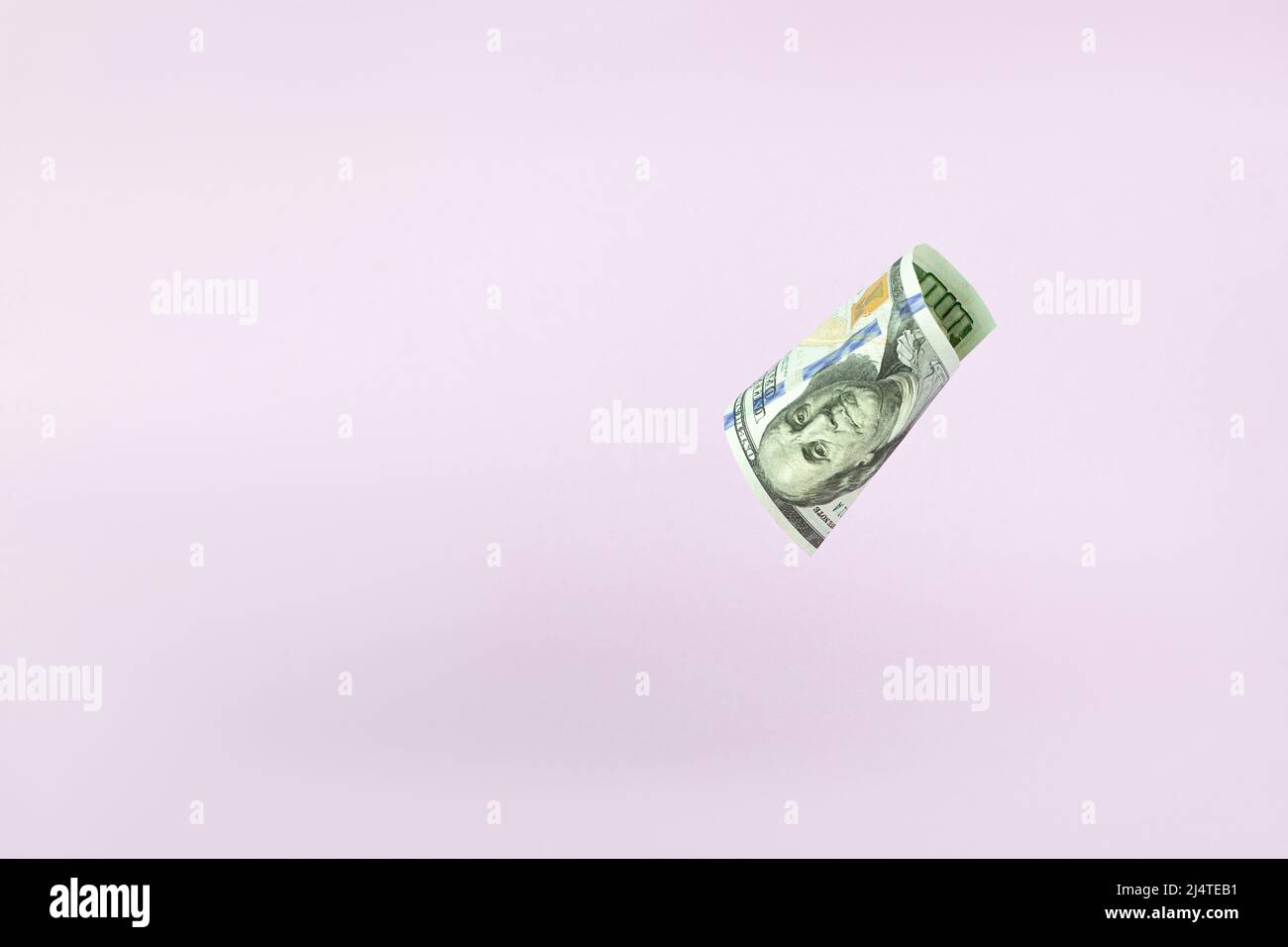 Flying one hundred dollars bills on pastel background. US 100 dollar bill close up. Stock Photo