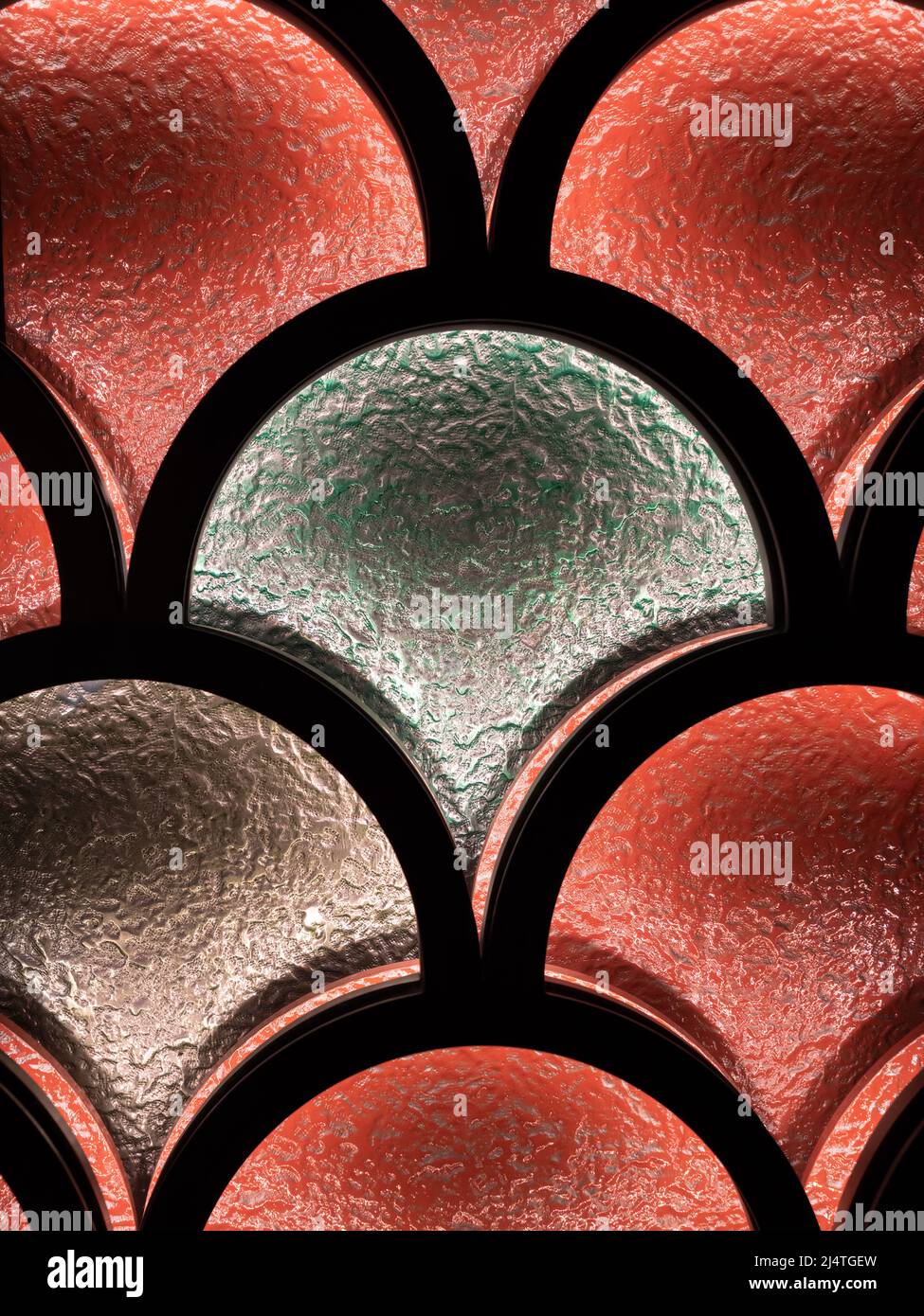 An abstract pattern on a colored window through which a light shines Stock Photo