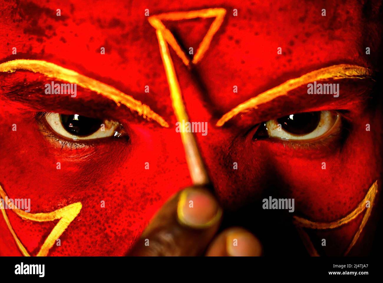 an-artist-with-a-face-paint-poses-for-a-photo-prior-to-a-tribal-art