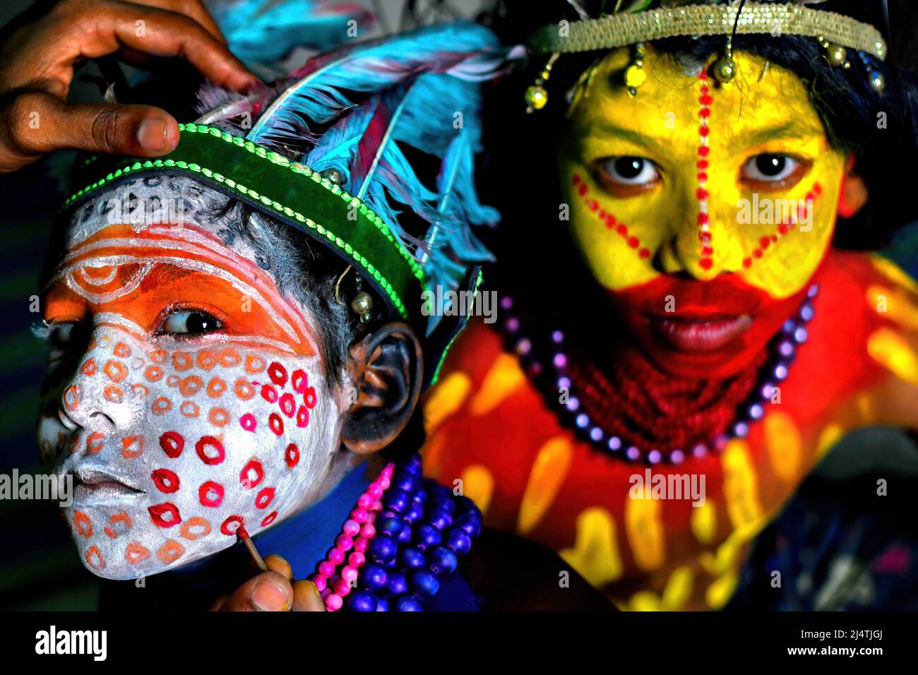 Young children pose with their faces painted as part of their ...