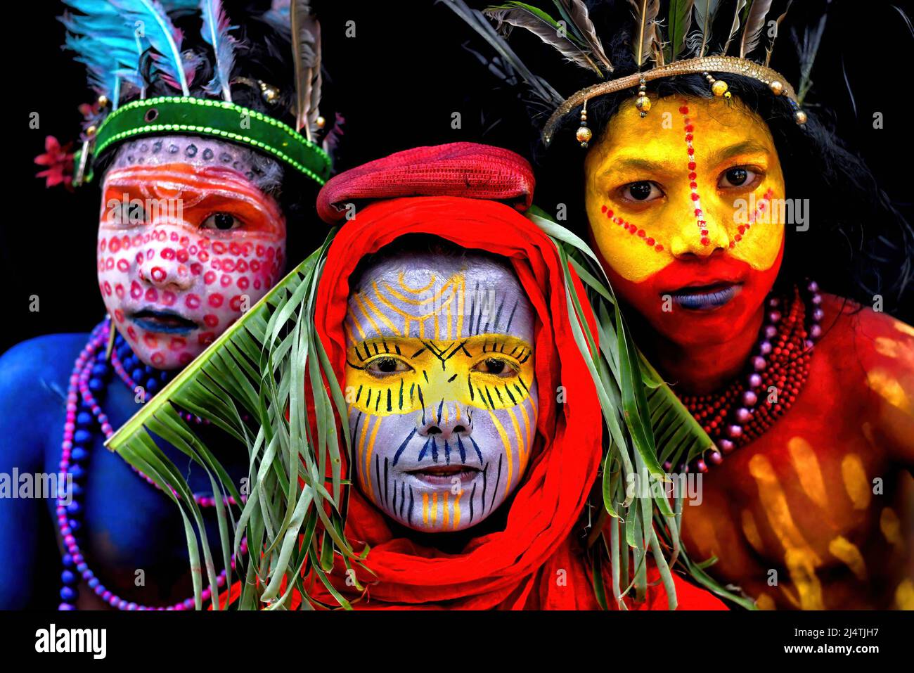 Young children pose with their faces painted as part of their ...