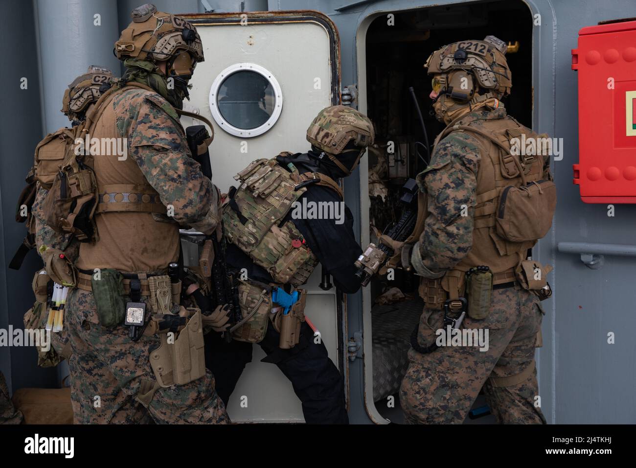 Royal Marines with 42 Commando and U.S. Marines with Charlie Company, 2nd Reconnaissance Battalion, assigned to 22nd Marine Expeditionary Unit, clear rooms during a visit, board, search, and seizure training mission in the Atlantic Ocean in support of exercise Northern Viking 2022, April 12, 2022. Northern Viking 22 strengthens interoperability and force readiness between the U.S., Iceland and Allied nations, enabling multi-domain command and control of joint and coalition forces in the defense of Iceland and Sea Lines of Communication in the Greenland, Iceland, United Kingdom (GIUK) gap. (U.S Stock Photo