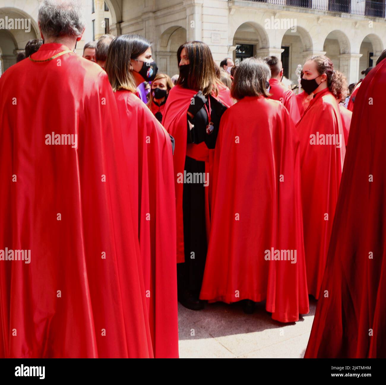 People dressed in traditional cloaks after the Easter Sunday procession in the Plaza Porticada Santander Cantabria Spain April 2022 Stock Photo
