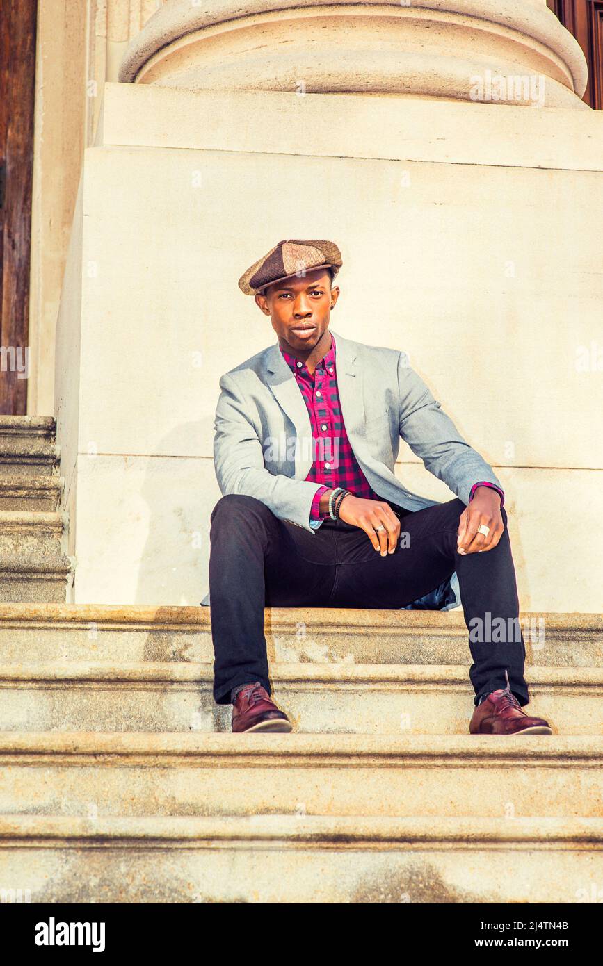 Man Urban Fashion. Wearing a Newsboy cap, dressing in light gray blazer,  patterned pink, black under shirt, black pants, brown leather shoes, a  young Stock Photo - Alamy