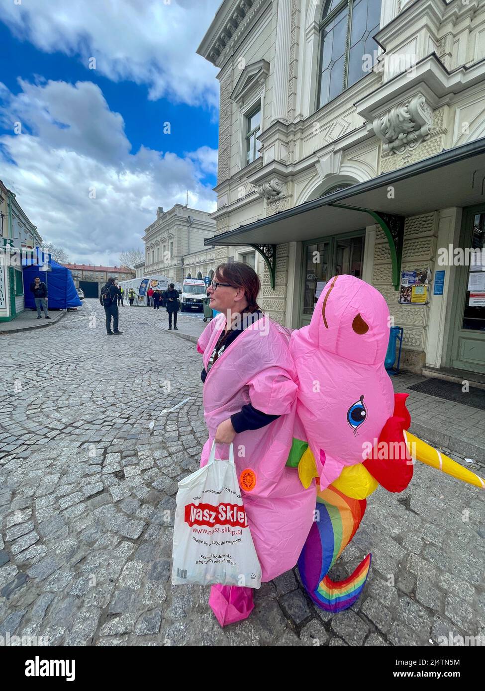 Przemysl, Poland. 17th Apr, 2022. Pink Unicorn under white, cotton candy  clouds and blue sky, giving away candy to Ukrainian refugee children on  Easter Sunday at the Przemysl train station, near border