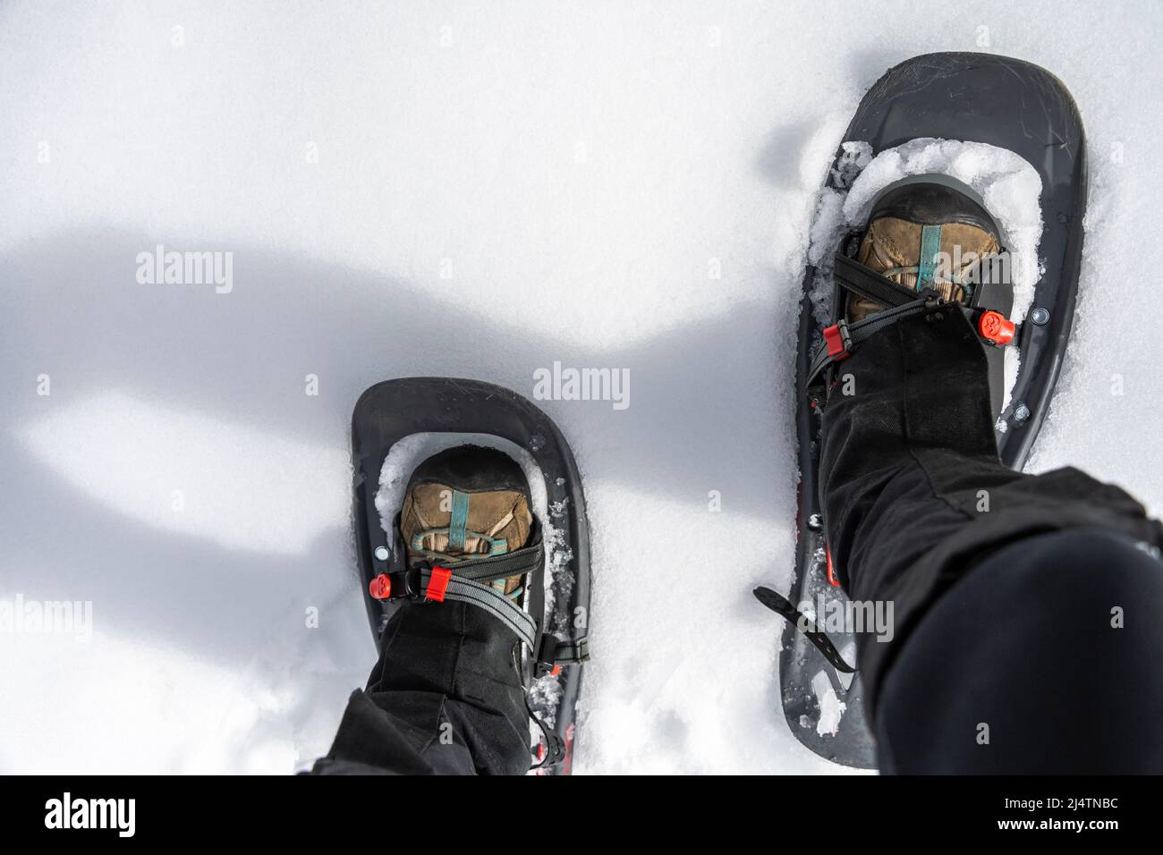 point of view image of a person walking in snowshoes Stock Photo