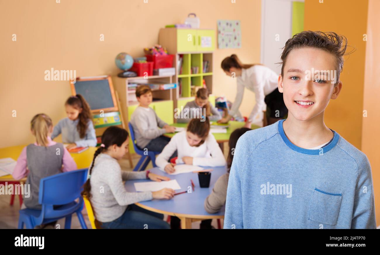 Happy schoolboy foreground in classroom with studying Stock Photo - Alamy