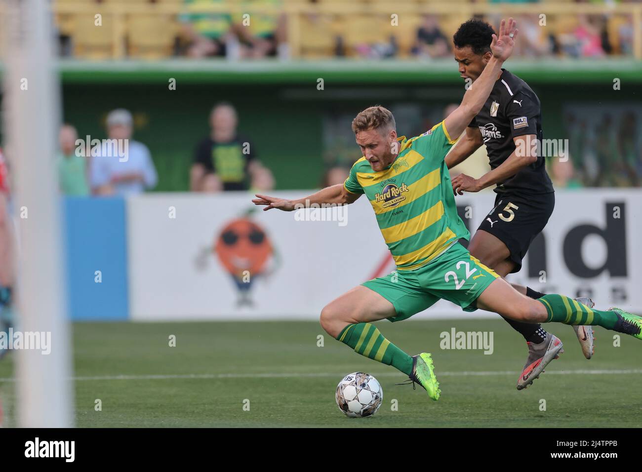 St. Petersburg, FL: Tampa Bay Rowdies forward Kyle Greig (22) is tripped up on the play by FC Tulsa midfielder Frantzly Zephirin (5) during a USL socc Stock Photo