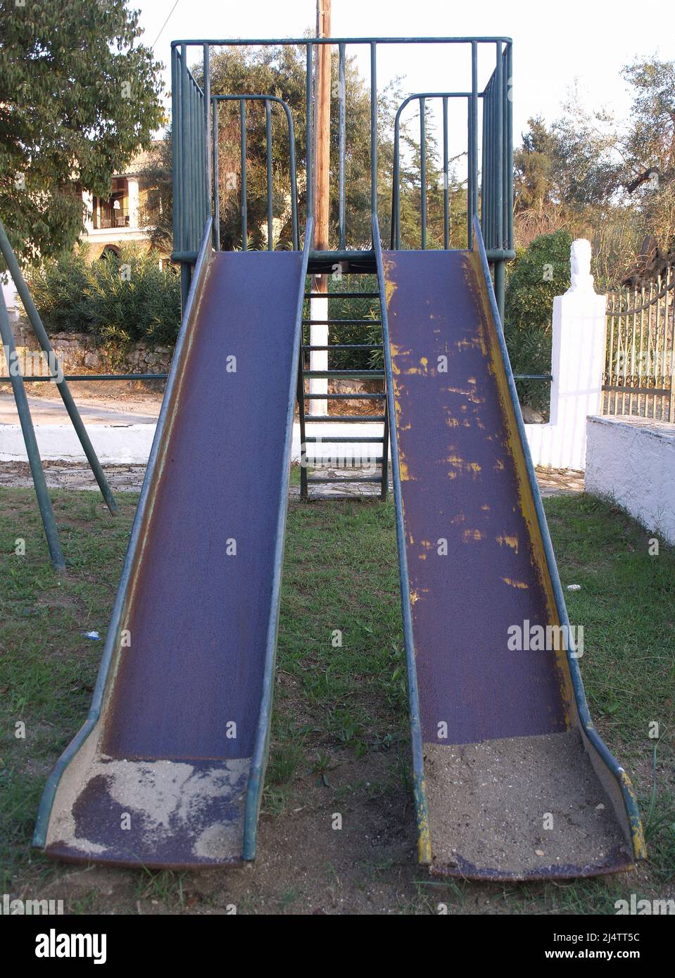 Well worn children's slide in playground at Xanthates, Corfu, Greece