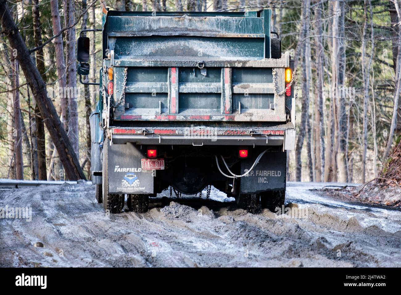 Trucks on muddy roads in Mud Season, the descent of Vermont dirt roads into mud bogs, happens every spring. State of Vermont, USA. Stock Photo