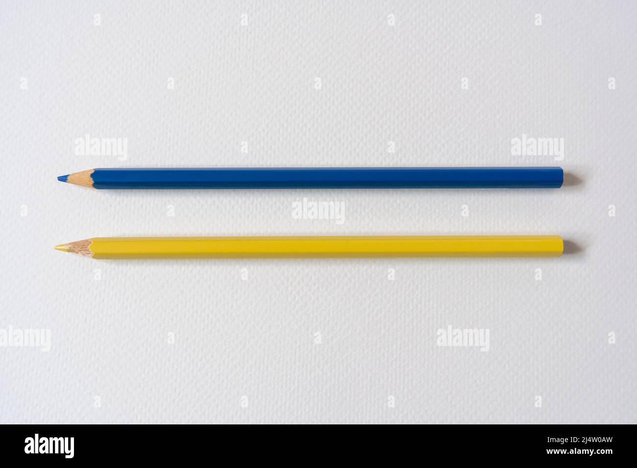 Blue and yellow colored pencils on paper Stock Photo