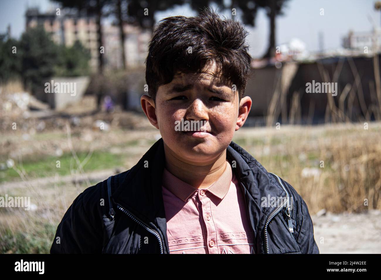 An Afghan boy lives in difficult conditions in Tehran after immigrating Stock Photo