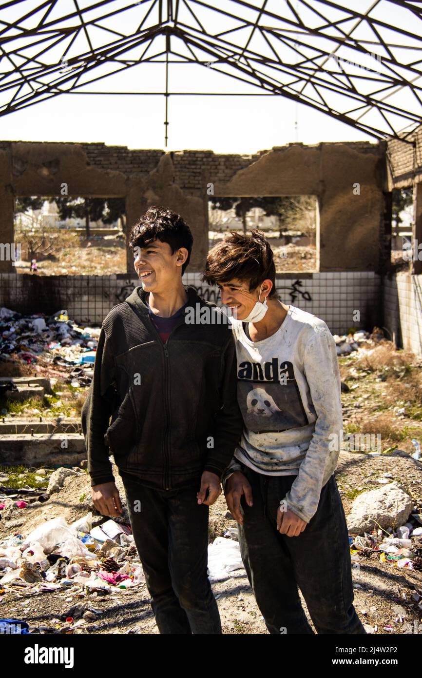 Two Afghan teenagers stand for a photo while laughing Stock Photo