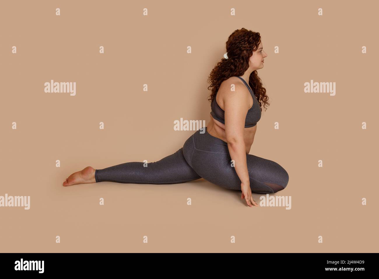 Attractive groomed fat obese plump woman doing sports stretch, sitting ...