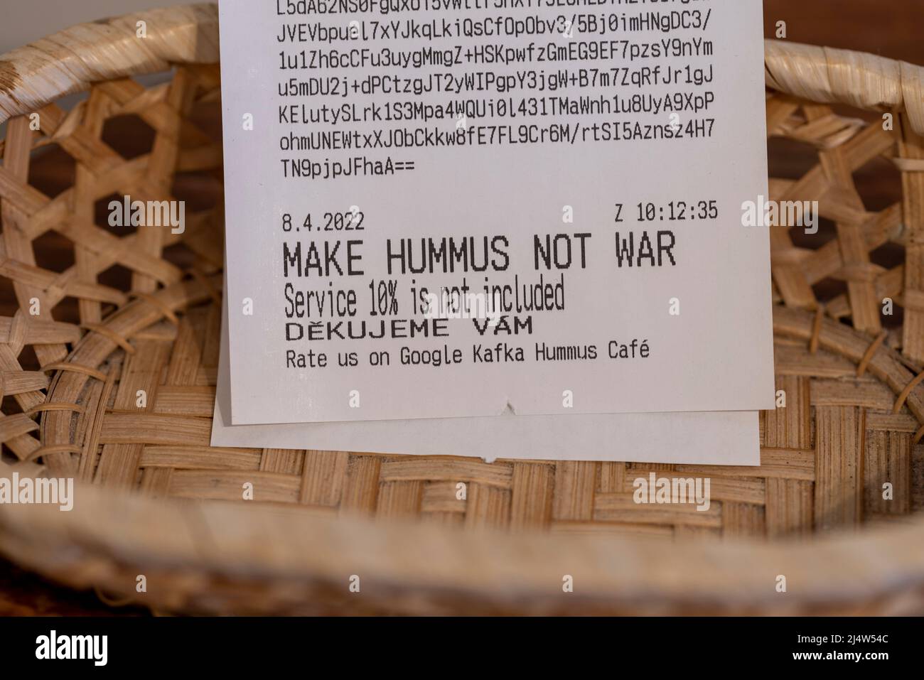 The words - MAKE HUMMUS NOT WAR - are written on a receipt at the Kafka Hummus Café in Prague. Stock Photo