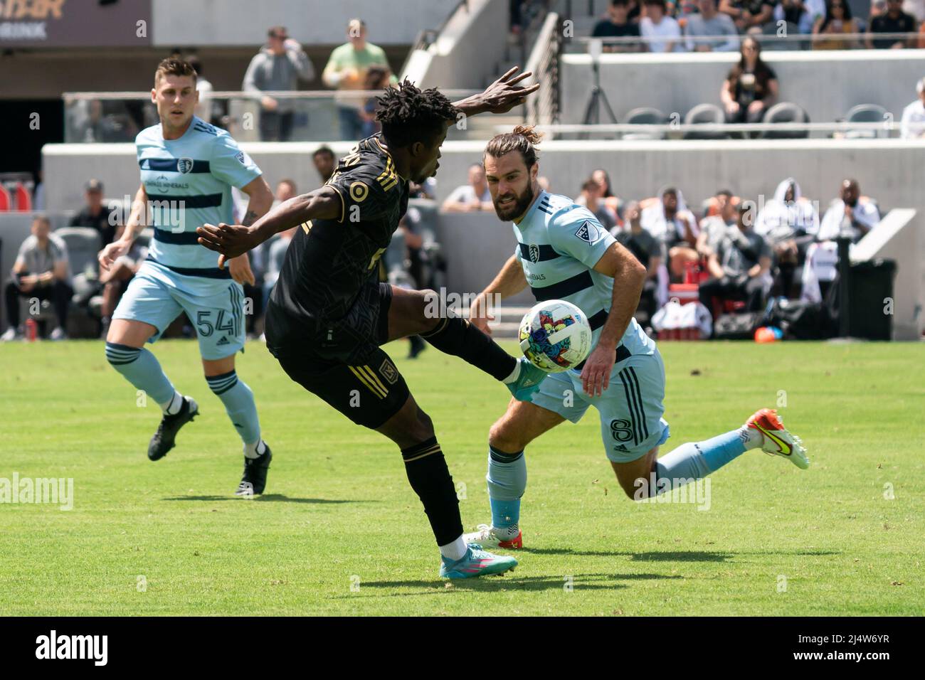 Los Angeles FC forward Kwadwo Opoku (22) is defended by Sporting Kansas City midfielder Graham Zusi (8) during a MLS match, Sunday, April 17, 2022, at Stock Photo