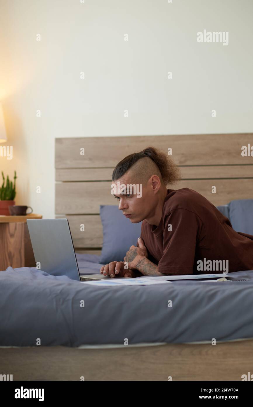 Serious young man lying in hi-res stock photography and images - Alamy