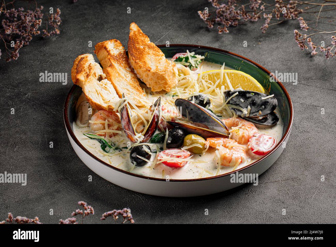 Portion of seafood saute with wheat bread Stock Photo