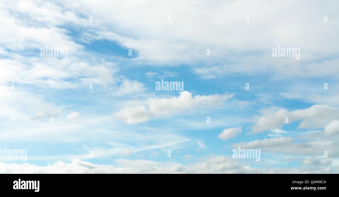 White fluffy clouds on blue sky. Soft touch feeling like cotton. White puffy cloudscape. Beauty in nature. Close-up white clouds texture background. Stock Photo