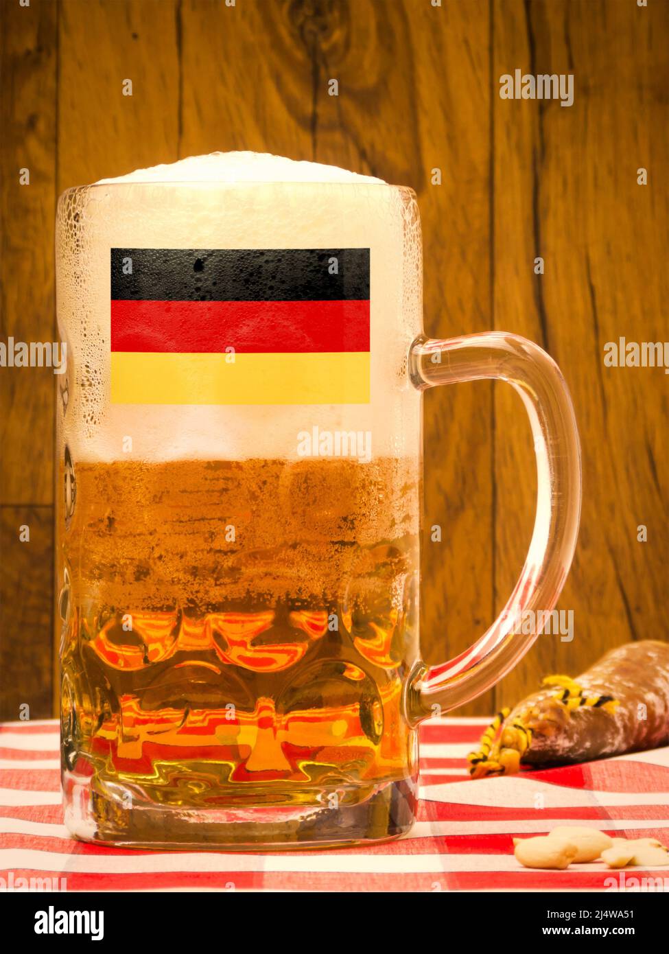 German pint of beer with flag on table with sausage Stock Photo