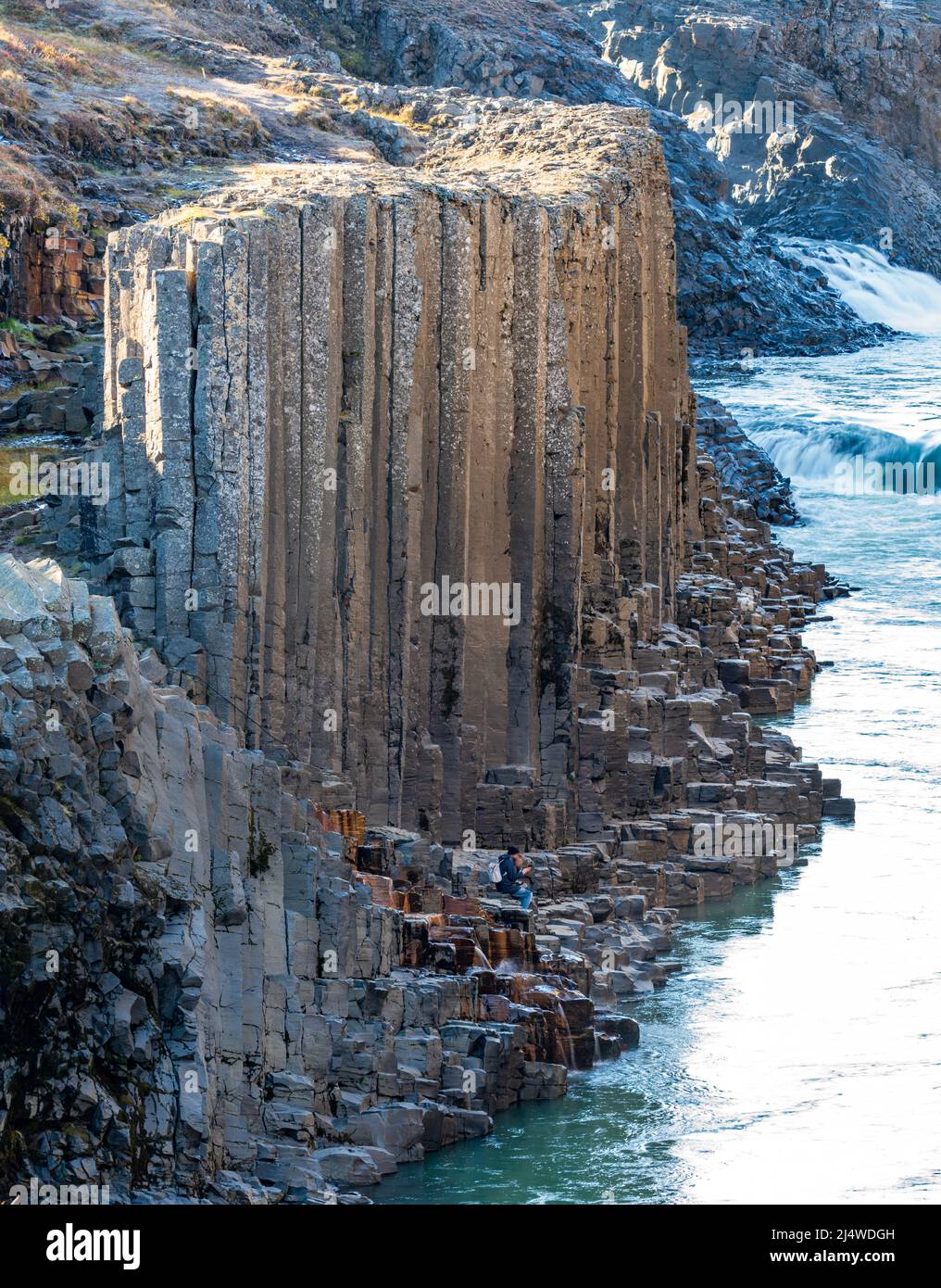 Unrecognizable couple inside basalt columns and river canyon Stock Photo