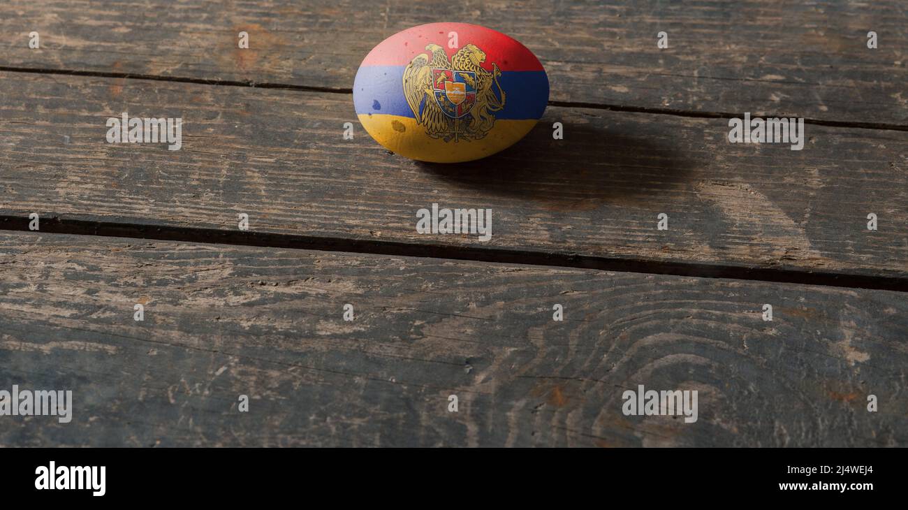 Flag of Armenia on a painted egg on a wooden board. Easter in Ukraine. Painted eggs. Easter holiday Stock Photo