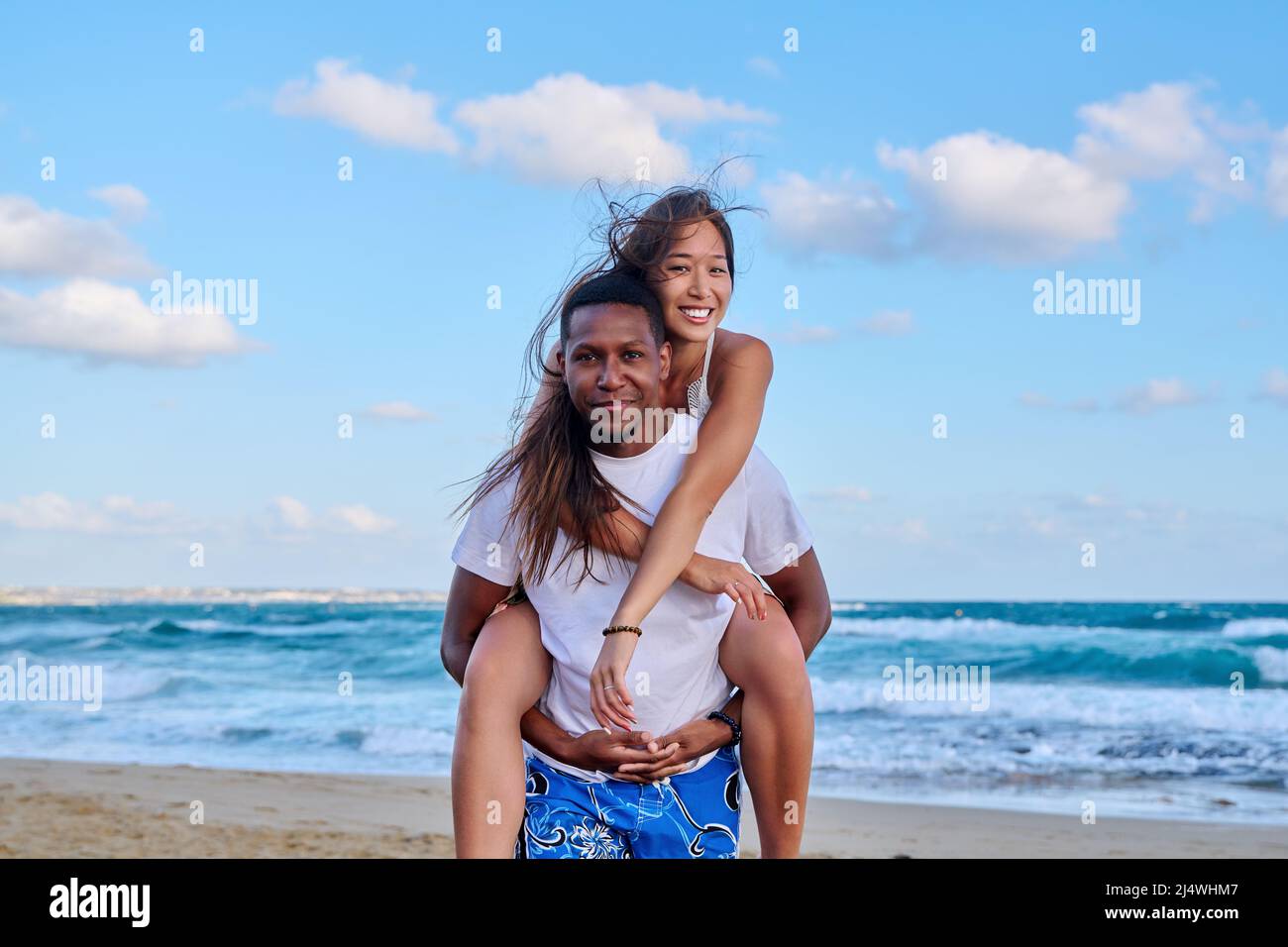 Happy young beautiful couple having fun on the beach. Stock Photo