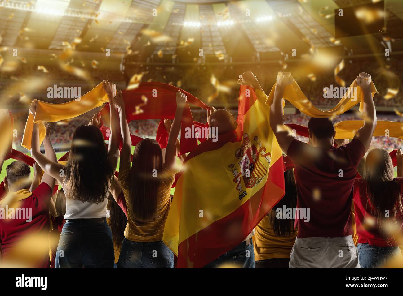 Back view of football, soccer fans cheering their team with state flags and scarfs at crowded stadium at evening time. Concept of sport. Out of focus Stock Photo