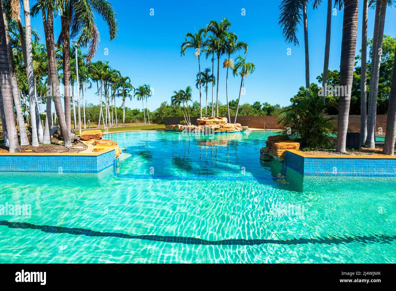 Large exotic swimming pool with palm trees in Broome, Western Australia, WA, Australia Stock