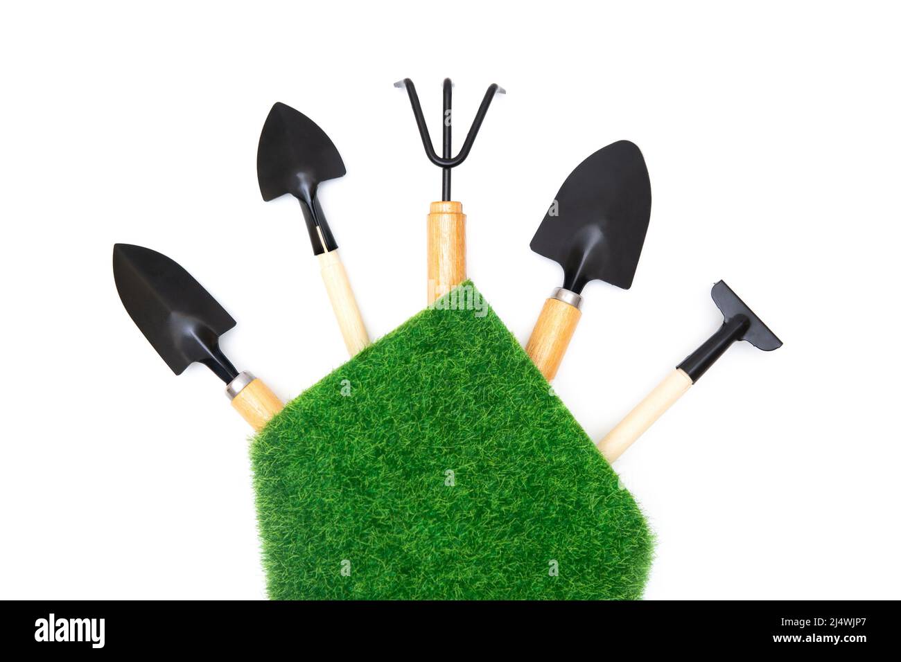 Selection of the essential gardening tools wrapped with a grass patch isolated on white background with copy space. Stock Photo