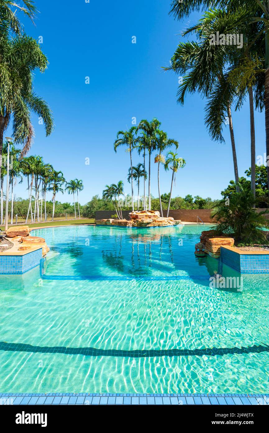 Vertical view of a large exotic swimming pool with palm trees in Broome ...