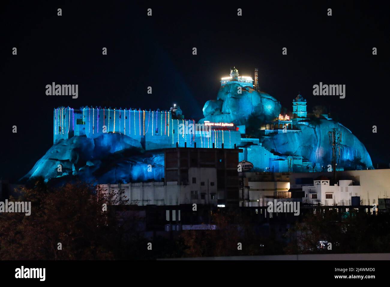 Rockfort Temple and rock are illuminated in different colours during the Purnima (Full Moon) festival  in Trichy, Tamil Nadu, India Stock Photo