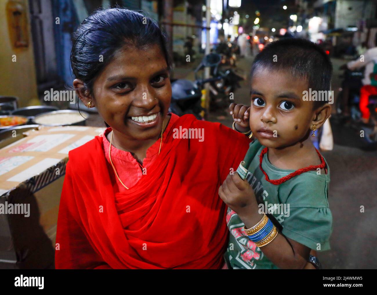 Portrait of a young Indian mother carrying her baby daughter in Trichy