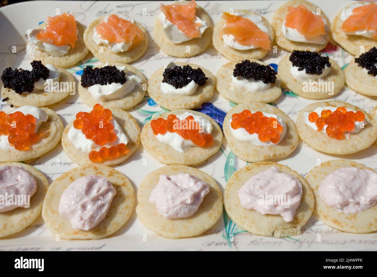 Blini with an assortment of toppings Stock Photo