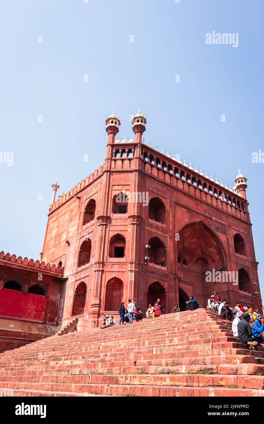 ancient mosque vintage entrance gate with bright blue sky at morning from unique angle image is taken at jama masjid delhi india on Mar 30 2022. Stock Photo
