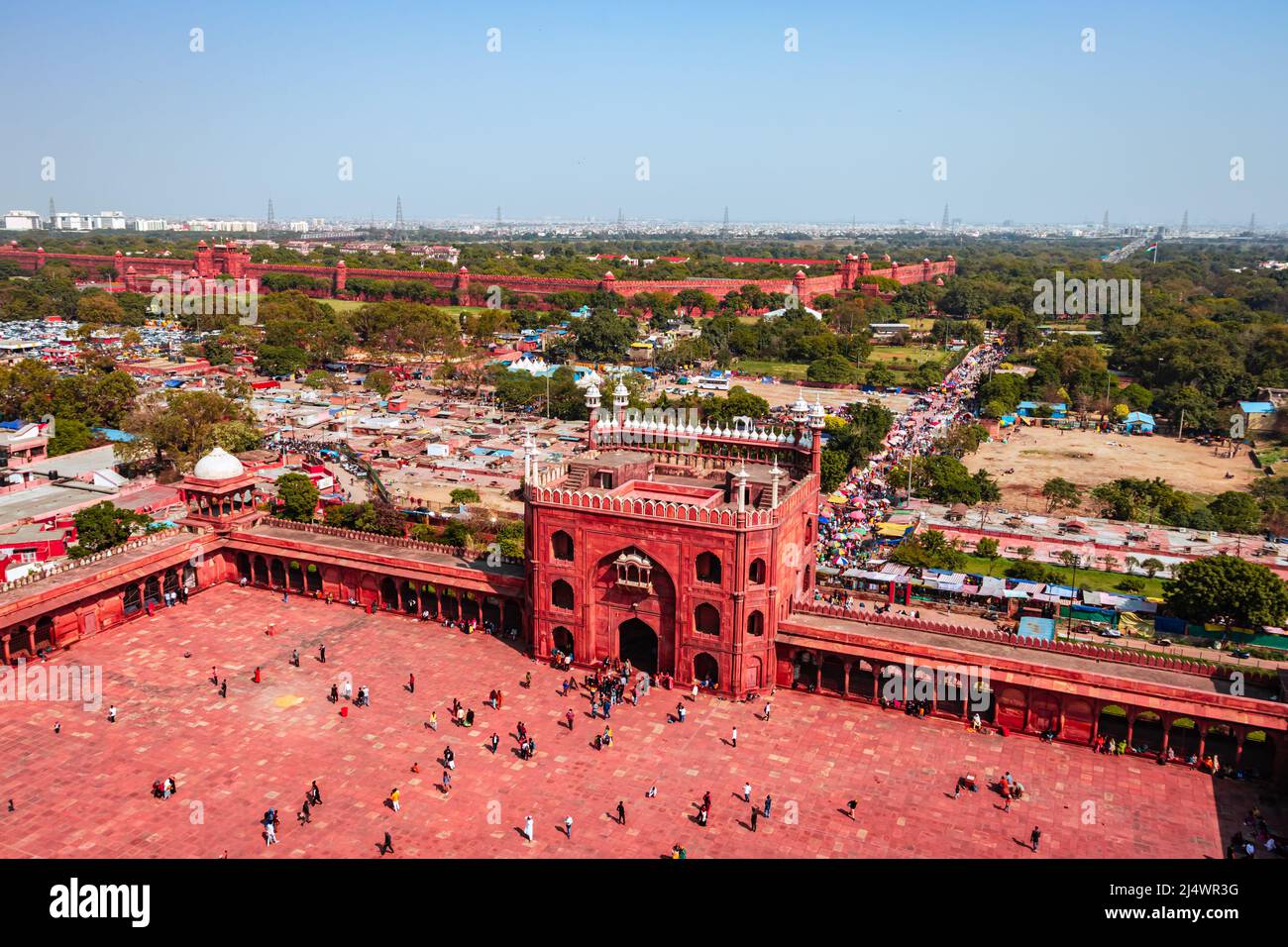 ancient mosque vintage entrance gate with people at morning from unique angle image is taken at jama masjid delhi india on Mar 30 2022. Stock Photo