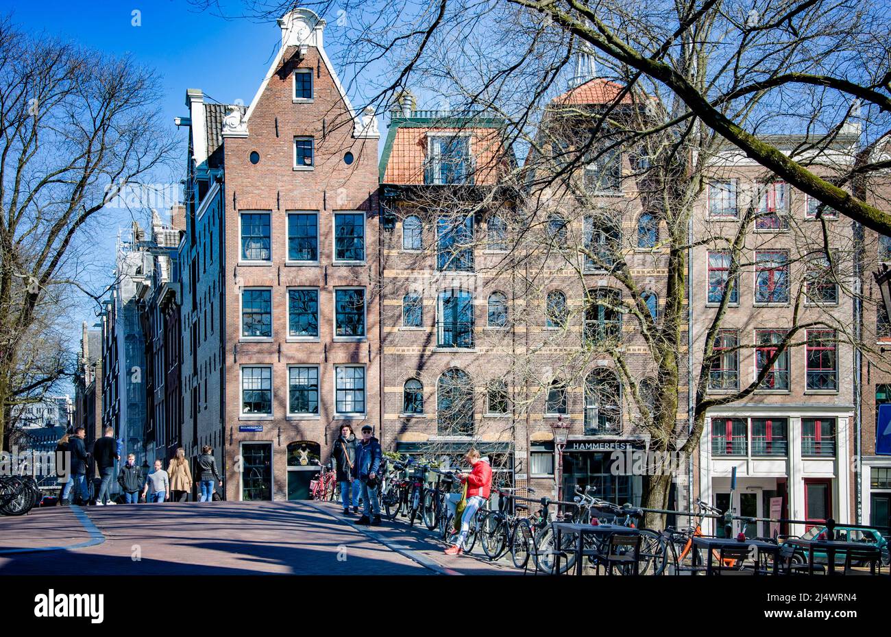 AMSTERDAM, NETHERLANDS. MARCH 19, 2022.Beautiful view of the city from the chanel. Traditional architecture Stock Photo