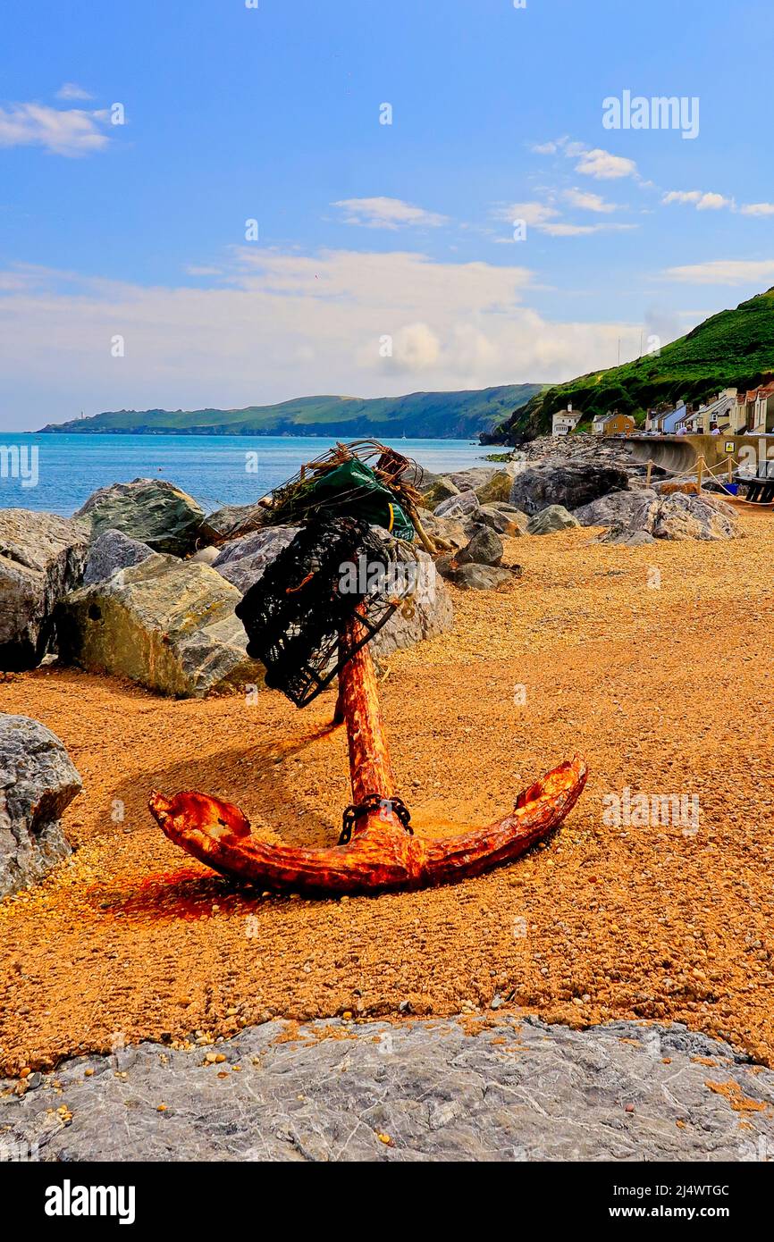 An old rusty Anchor on the beach at Beesands Stock Photo