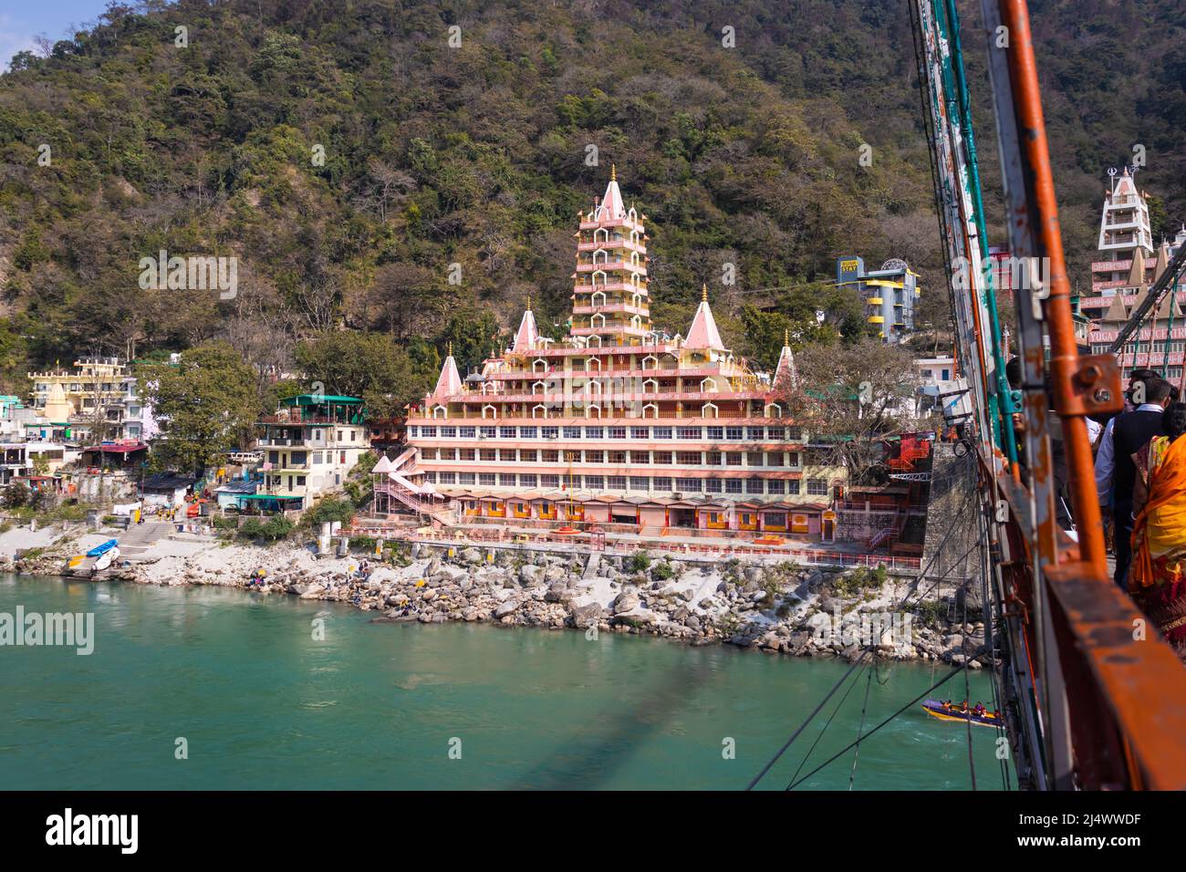 ancient hindu temple at ganges river bank at day from flat angle image is taken at trimbakeshwar temple lakshman jhula rishikesh uttrakhand india on M Stock Photo