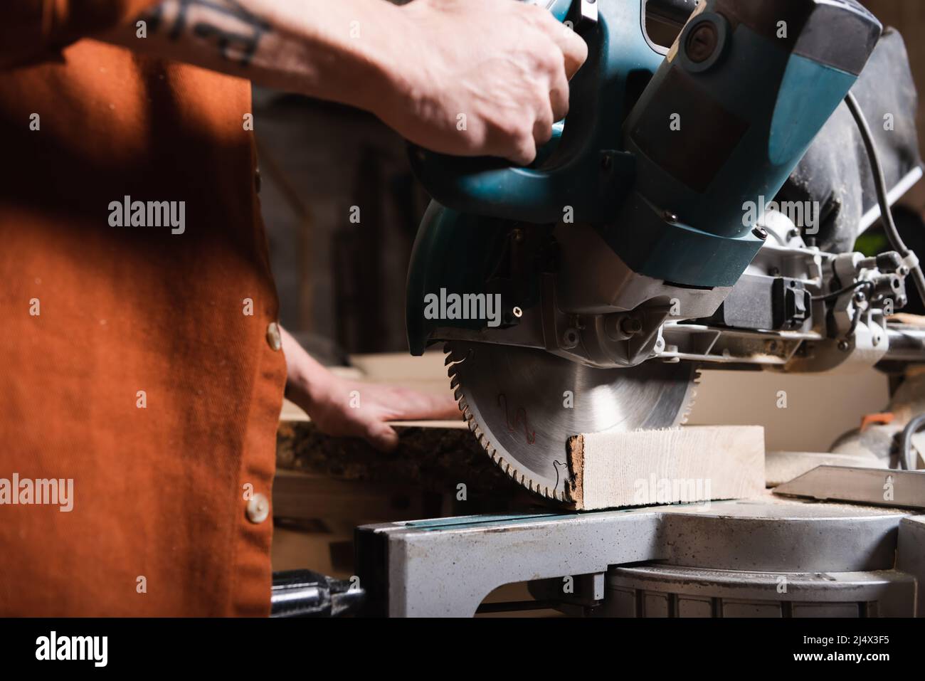 partial view of joiner cutting timber with miter saw Stock Photo Alamy