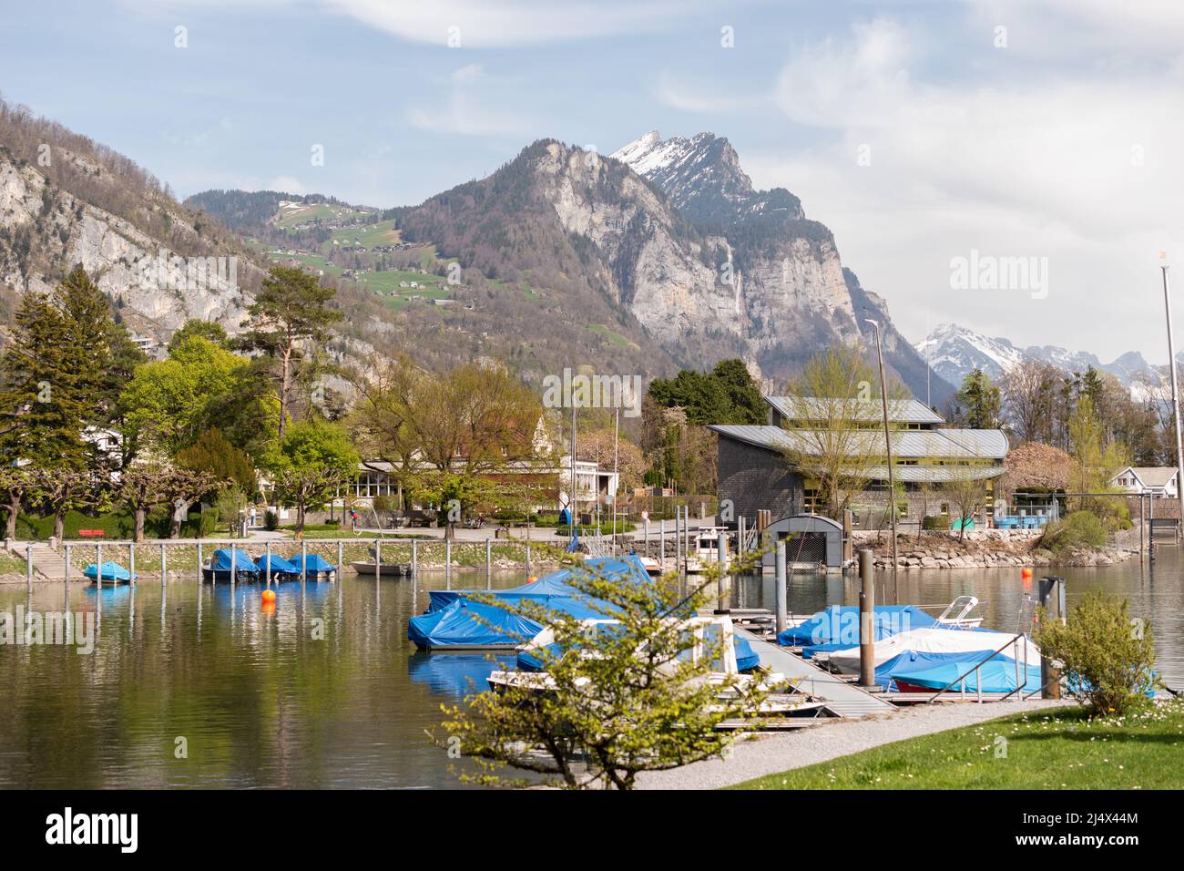 Walensee Spring Weesen, Switzerland, April 13, 2022 Tiny boats are drifting at a little ...