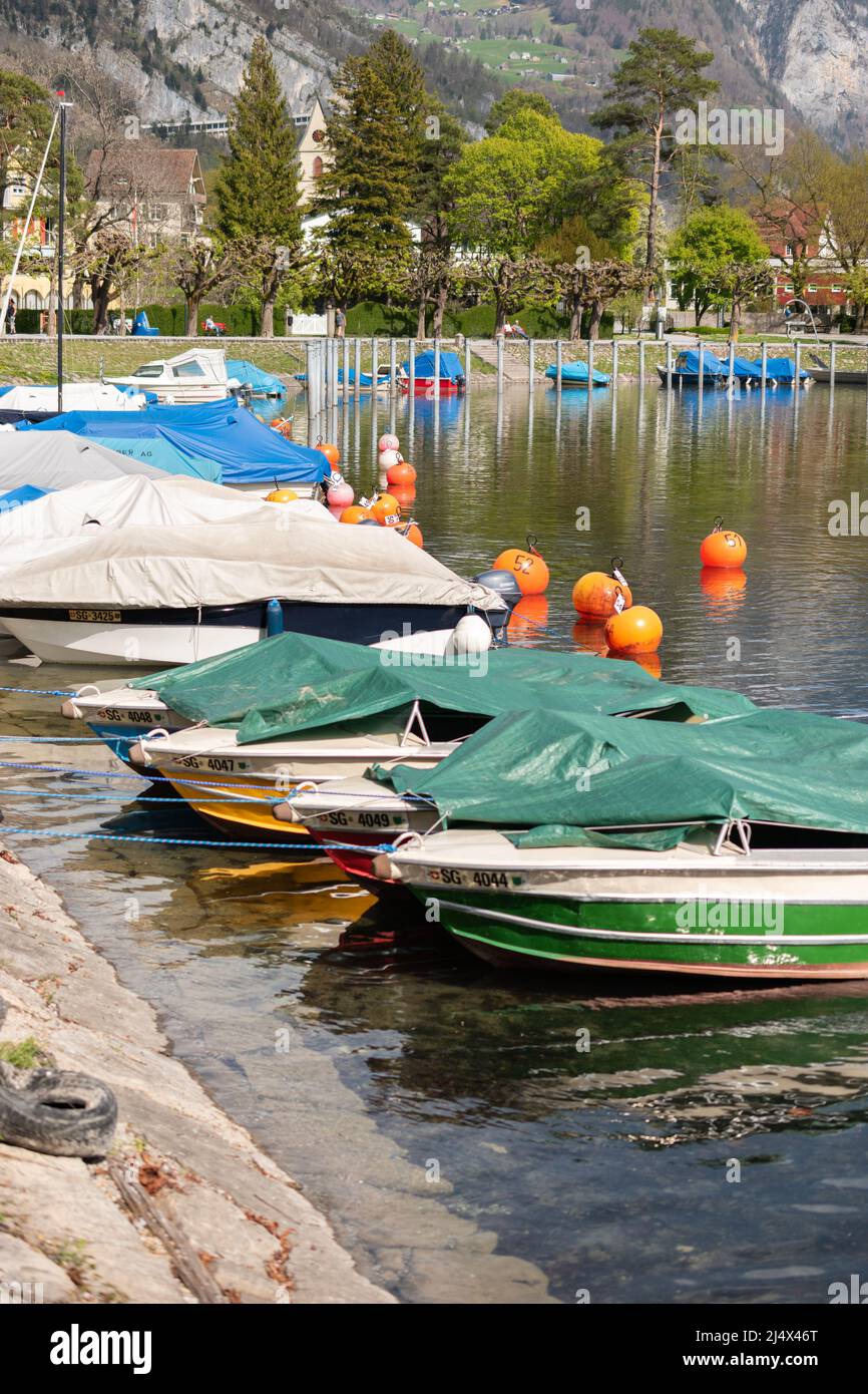 Walensee Spring Weesen, Switzerland, April 13, 2022 Tiny boats are drifting at a little ...