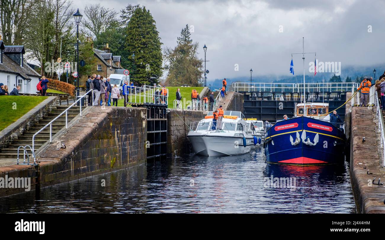 The tourist cruiser Scottish Highlander with other smaller boats making their way through the Caledonian Canal locks and into Loch Ness, Scotland Stock Photo