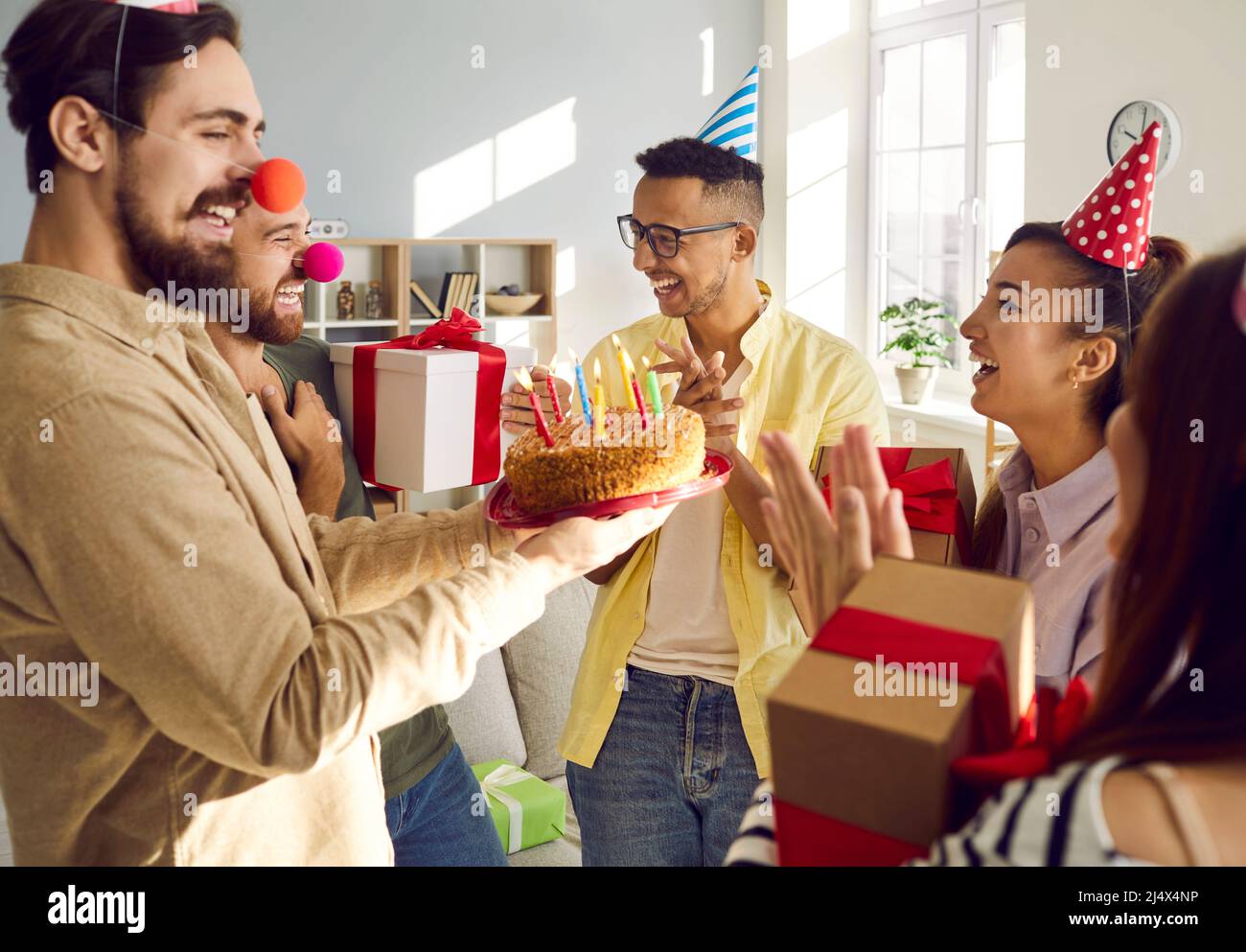 Smiling young people greeting friend with happy birthday Stock Photo