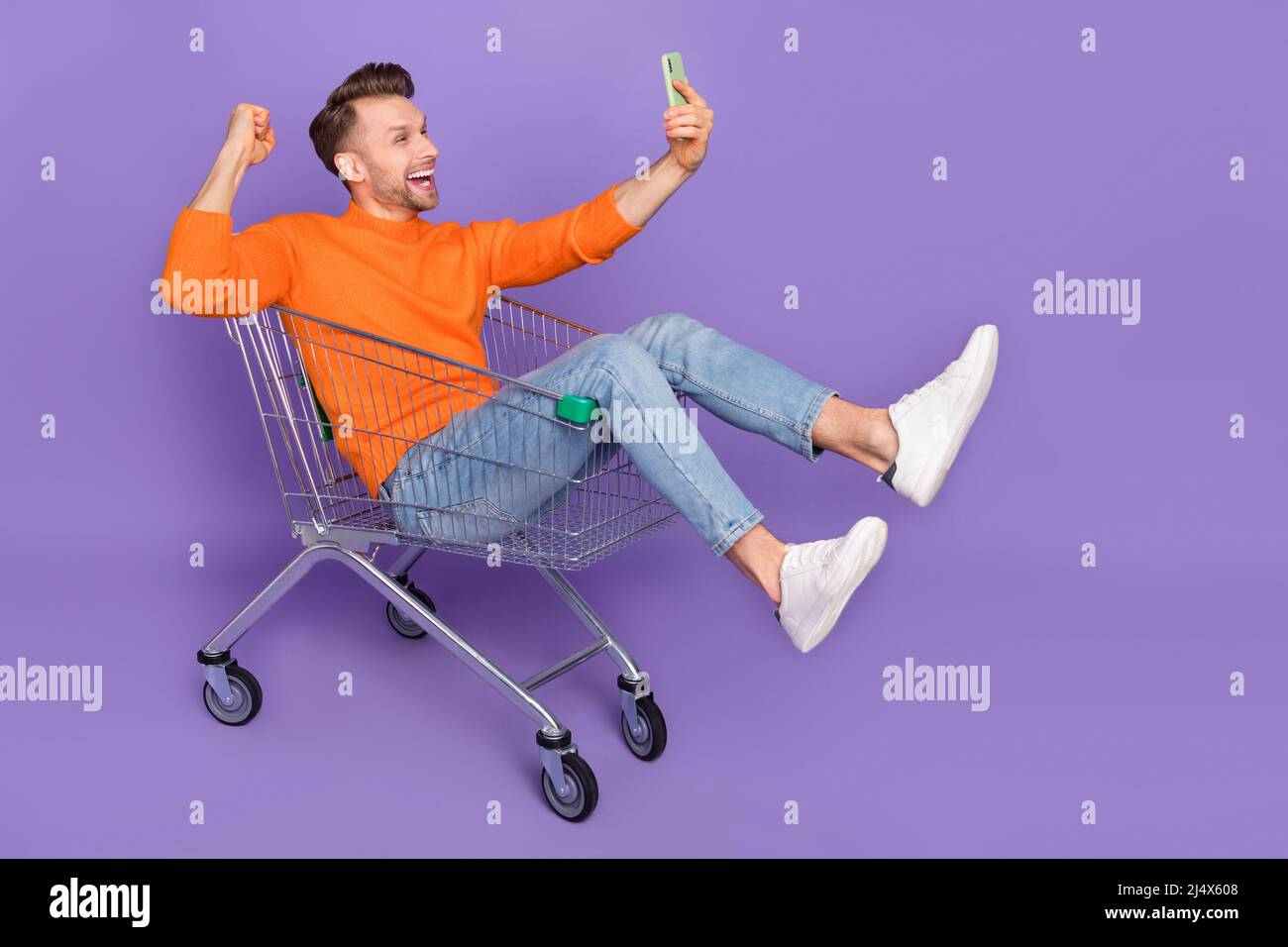 Photo of good mood positive shopaholic man raise fists win in lottery giveaway isolated on purple color background Stock Photo