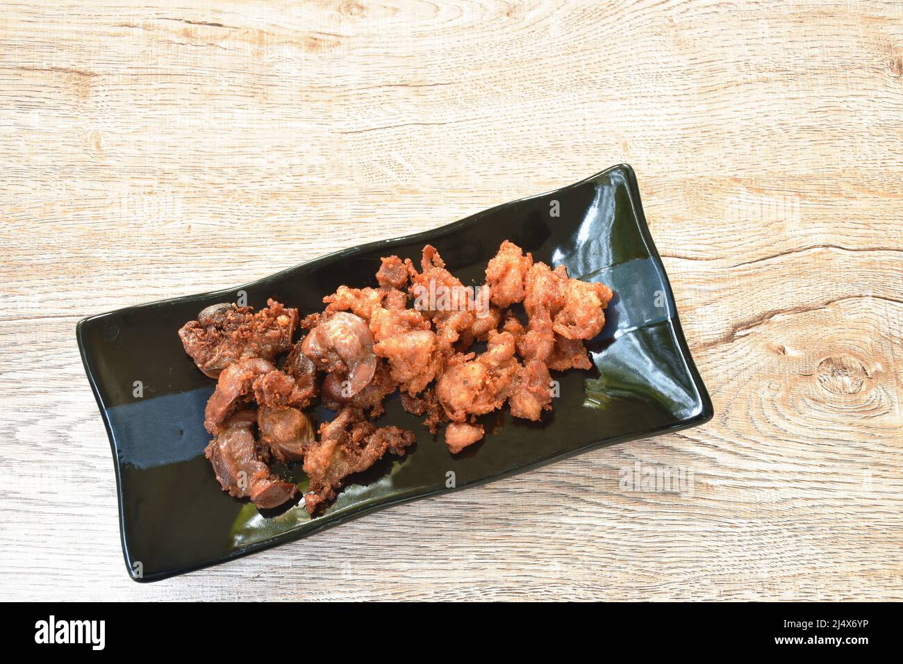 deep fried crispy salty chicken meat and gizzard on plate Stock Photo