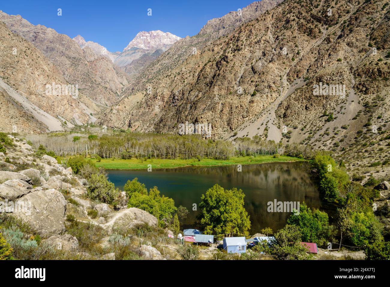 Scenic view of the mountains, small lake and a tourist camp in Tajikistan Stock Photo