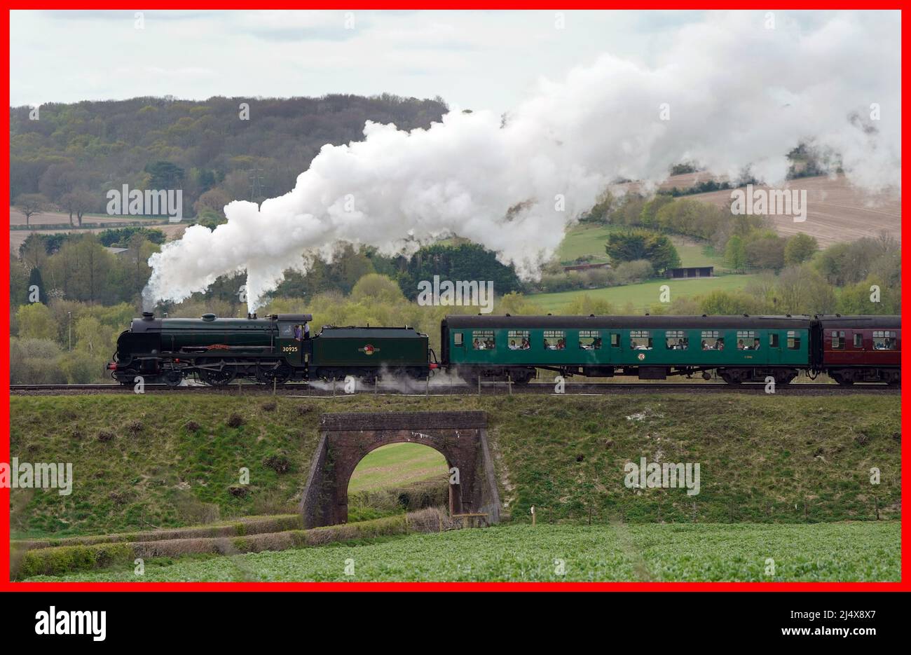 PABest The SR V Schools class steam locomotive Cheltenham makes it's way along the Mid Hants Railway, also known as the Watercress line, near to Ropley in Hampshire. Picture date: Monday April 18, 2022. Stock Photo