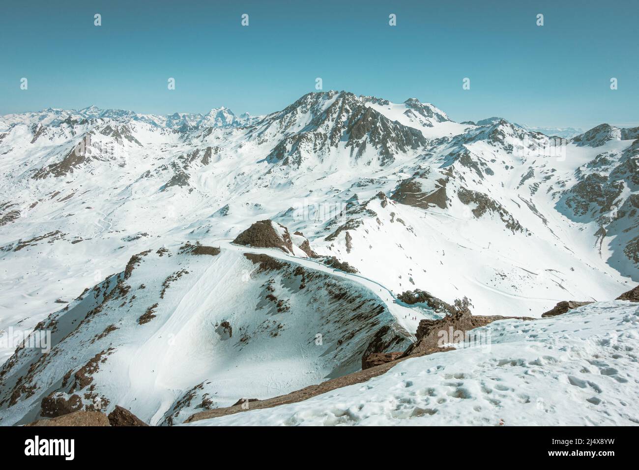 Top of French alps in the distance, range of mountains under snow, ski slopes in Val Thorens, France Stock Photo