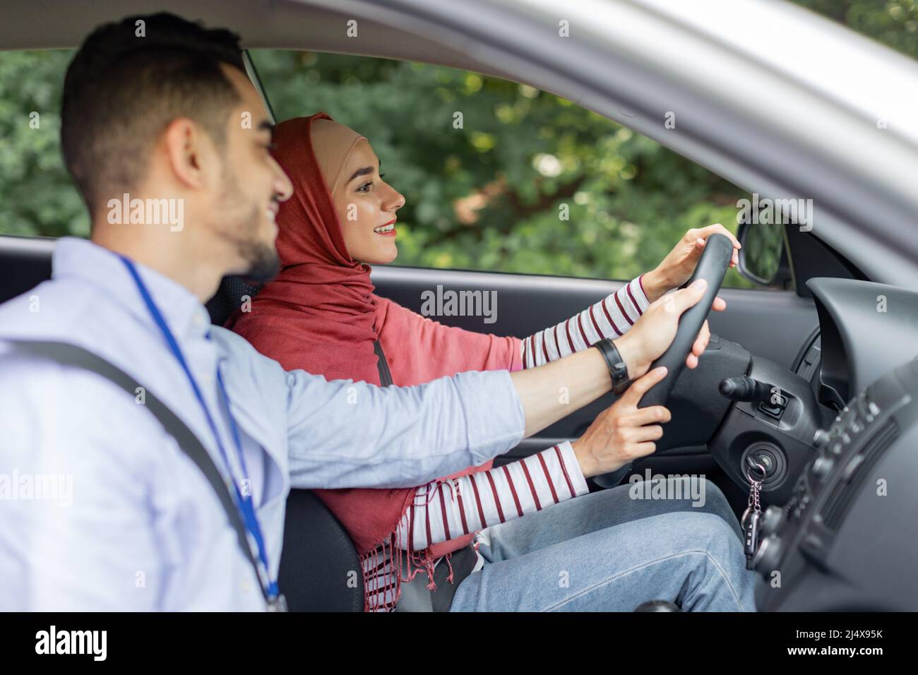 Happy attractive millennial arabic man teaching student, helping to